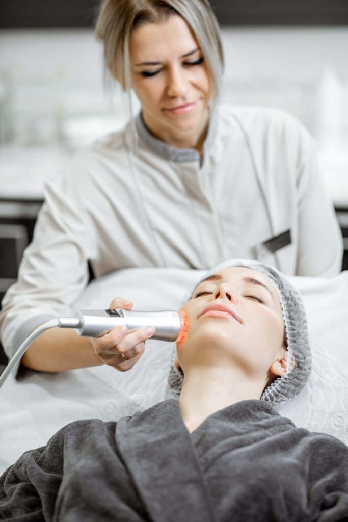 Cosmetologist making facial treatment to a woman