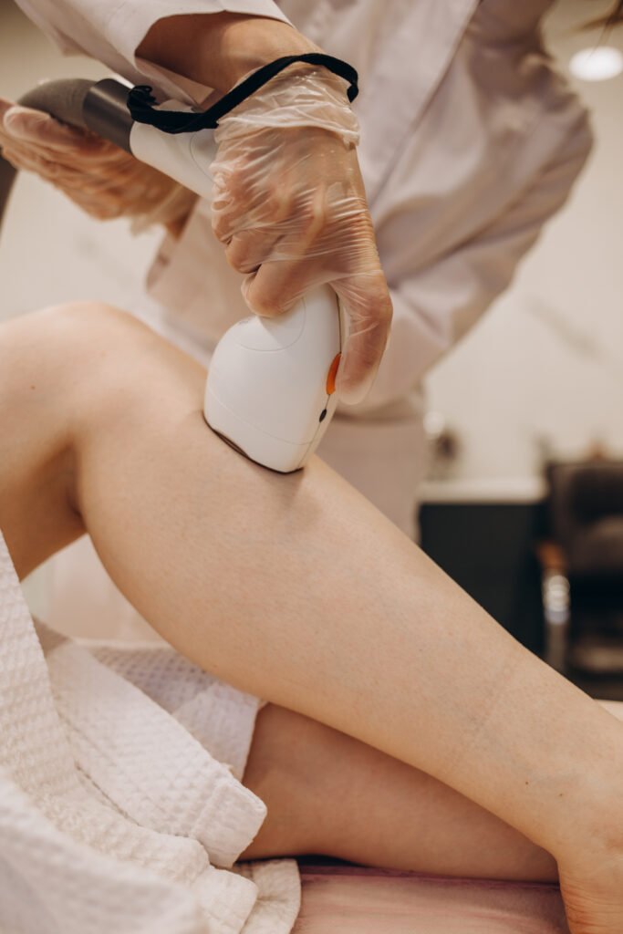 master makes the girl's legs a laser hair removal procedure