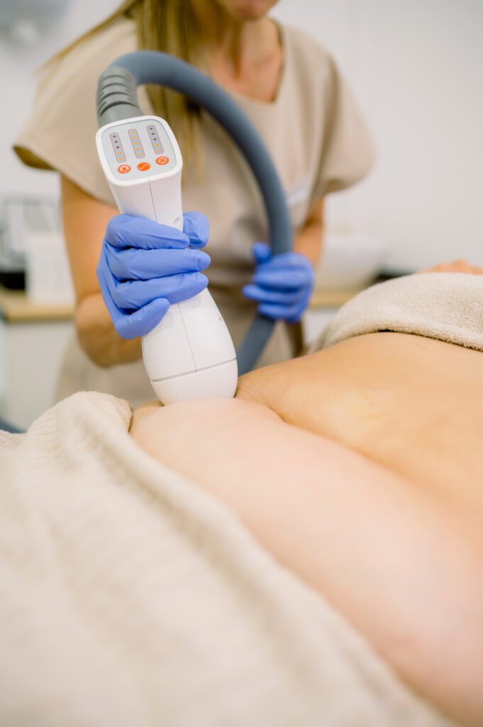 Woman giving fat reducing treatment